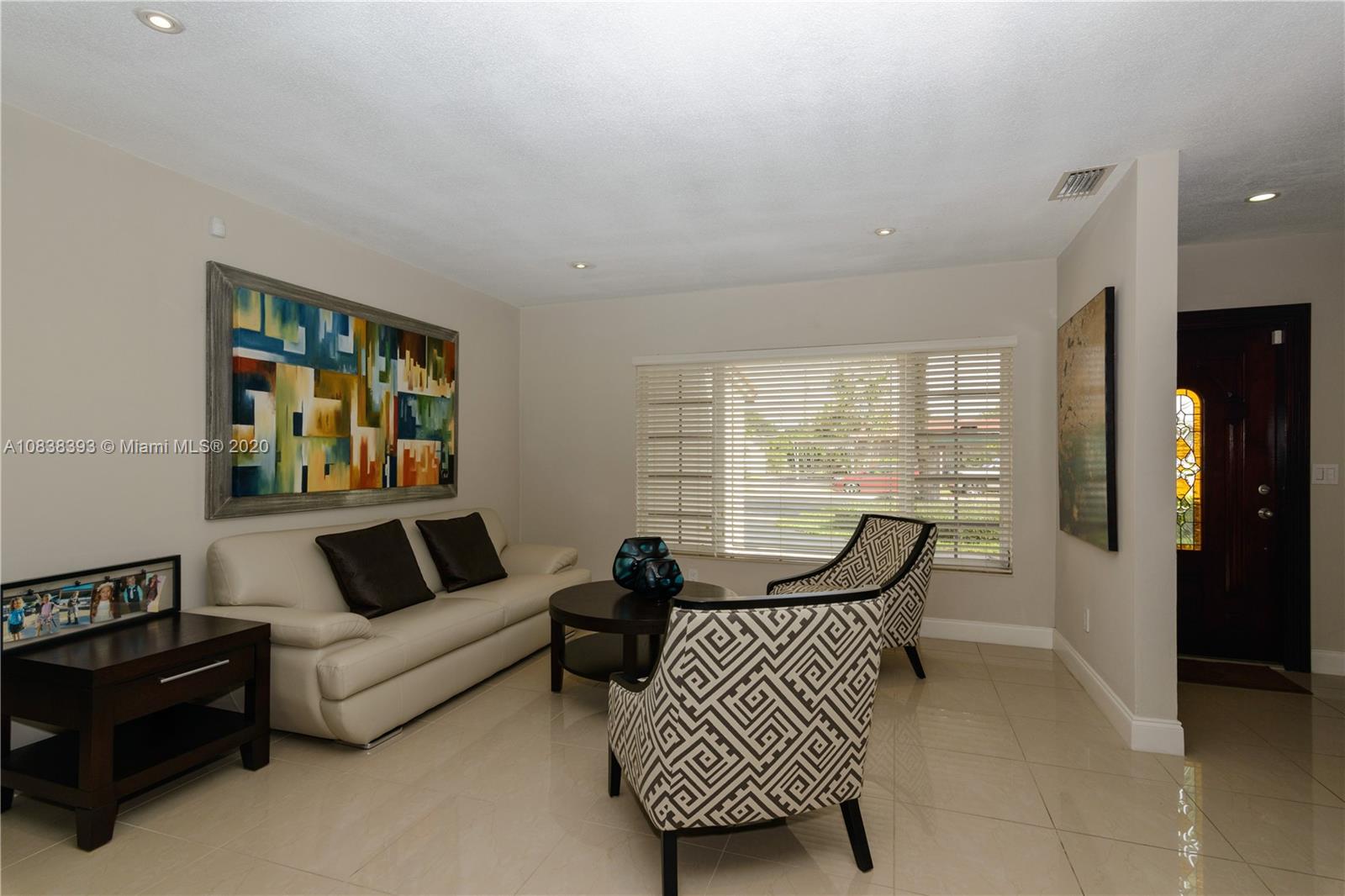1220 West 62nd Street Hialeah, FL 33012 - Photo 24 of 53 a living room with furniture and a large window