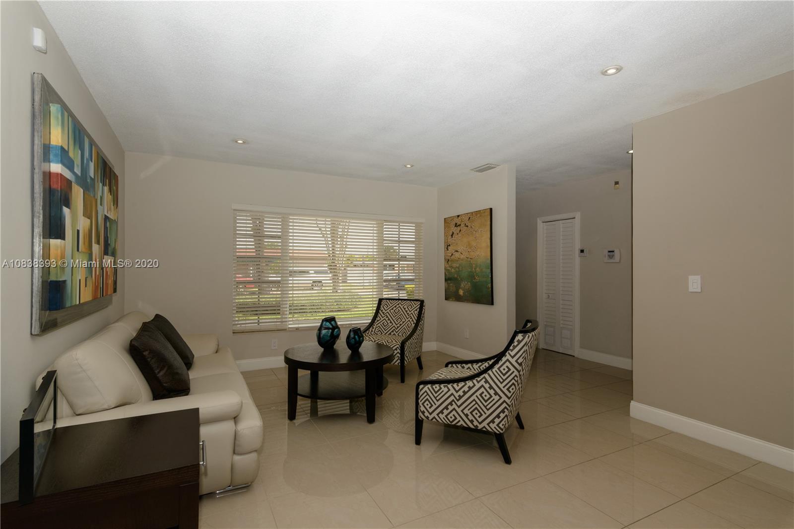 1220 West 62nd Street Hialeah, FL 33012 - Photo 25 of 53 a living room with furniture and a floor to ceiling window