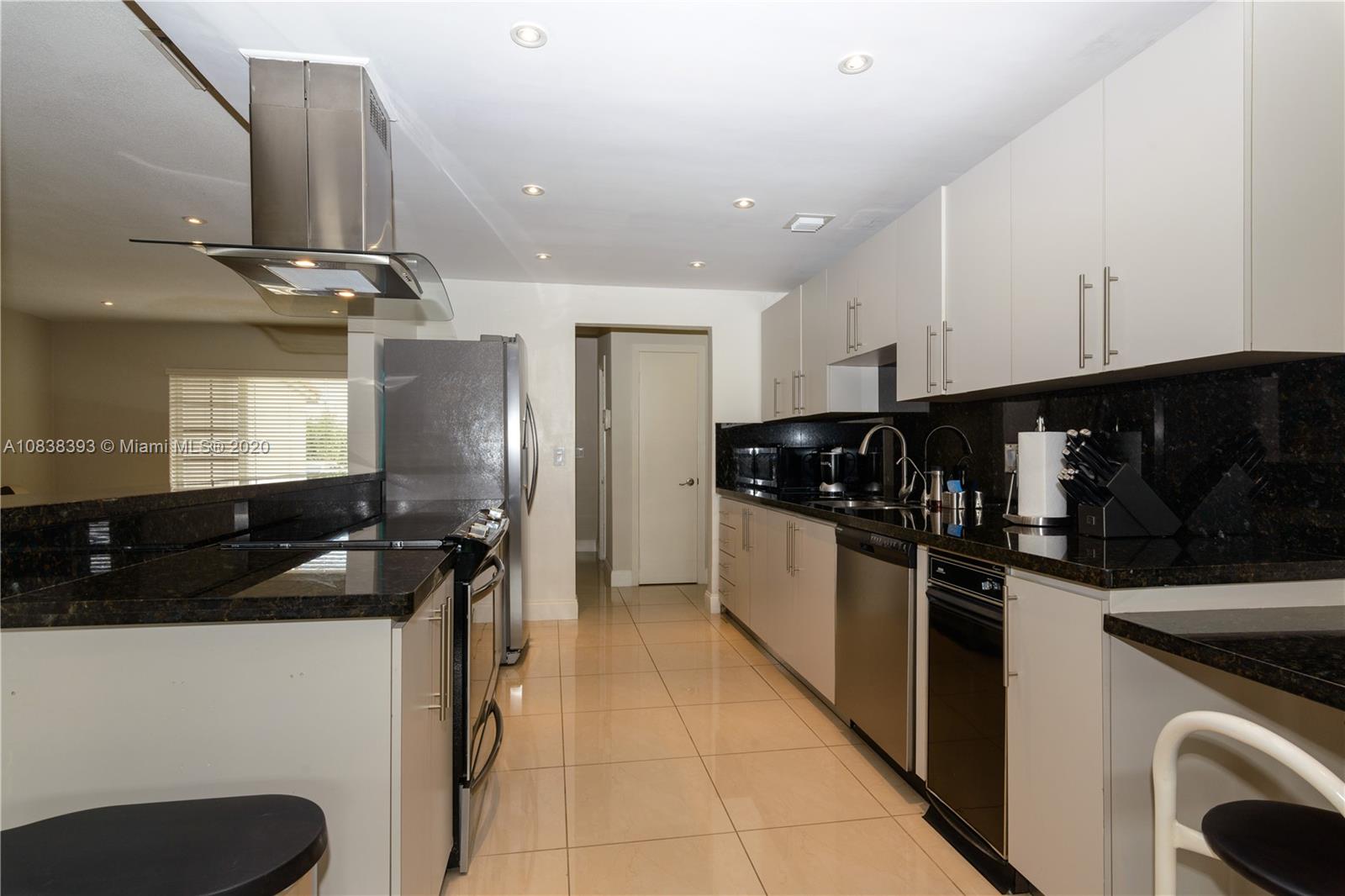 1220 West 62nd Street Hialeah, FL 33012 - Photo 27 of 53 a kitchen with a refrigerator and a sink