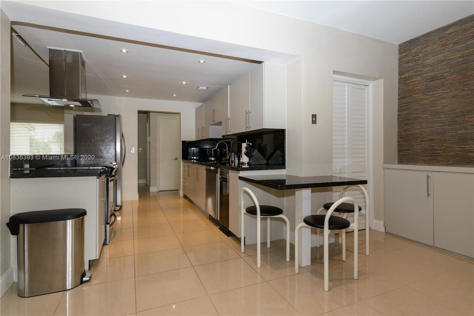 1220 West 62nd Street Hialeah, FL 33012 - Photo 29 of 53 a kitchen with stainless steel appliances kitchen island granite countertop a stove a sink and a refrigerator