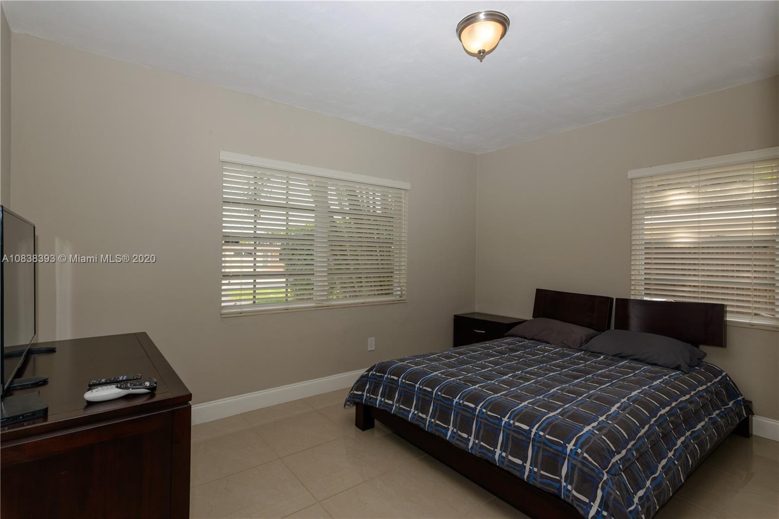 1220 West 62nd Street Hialeah, FL 33012 - Photo 35 of 53 a bedroom with a bed and a window
