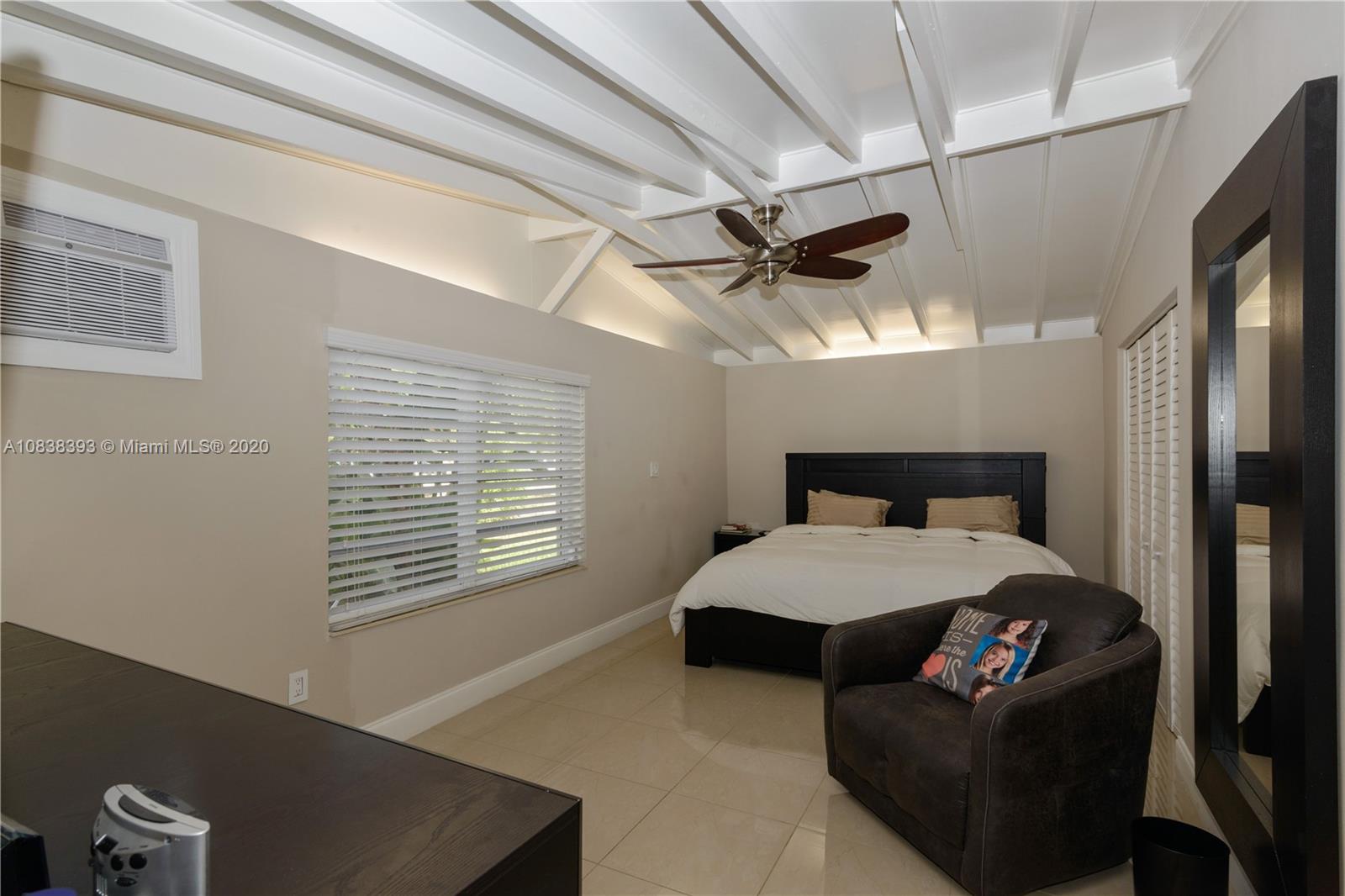 1220 West 62nd Street Hialeah, FL 33012 - Photo 36 of 53 a bedroom with a bed window and a ceiling fan