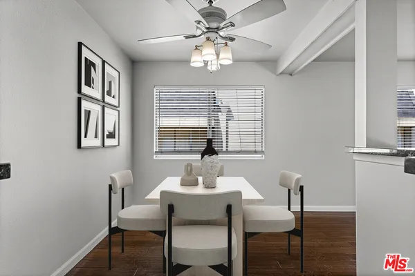 a dining room with furniture and window