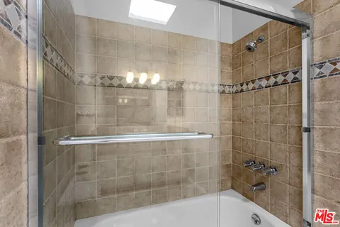 a bathroom with a shower and a mirror