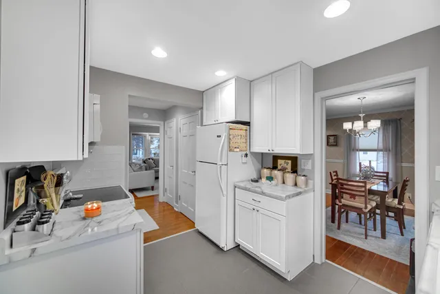 a kitchen with a stove cabinets and wooden floor