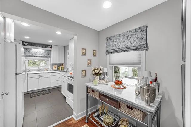 a view of a dining room with furniture a chandelier and wooden floor