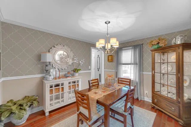 a view of a dining room with furniture and chandelier