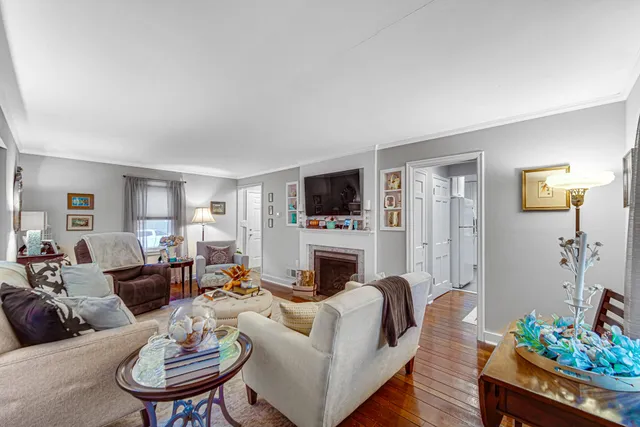 a living room with furniture and a painting on the wall