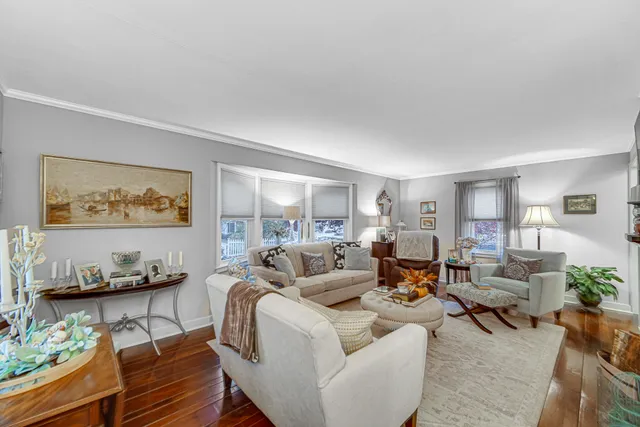 a living room with furniture or couch and a wooden floor