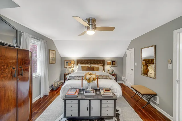 a spacious bedroom with a bed and large windows