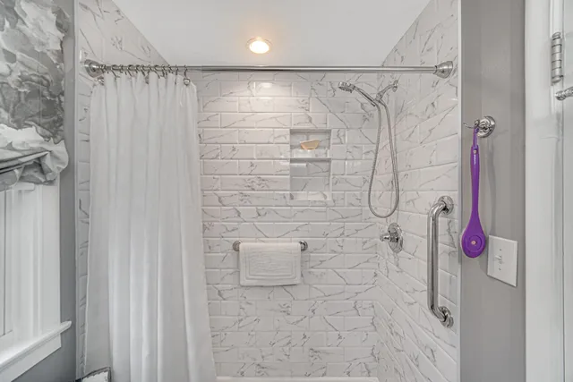 a living room with furniture a dining table and a refrigerator