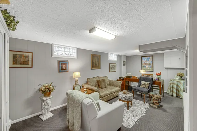 a living room with furniture and large window