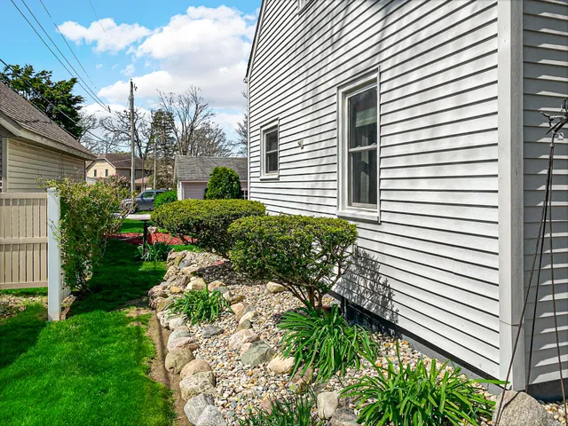 a front view of a house with potted plants