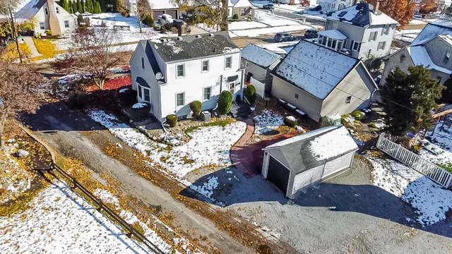 a view of a house with a yard and wooden fence