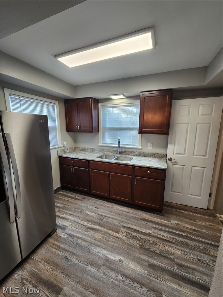 2199 North Taylor Road Cleveland Heights, OH 44112 - Photo 6 of 19 Kitchen with dark brown cabinets, sink, dark wood-type flooring, and fridge