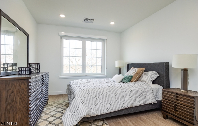 558 Market Street Newark, NJ 07105 - Photo 8 of 17 a bedroom with a bed and wooden floor