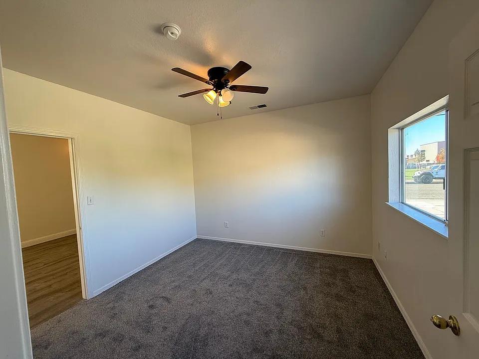 150 North Acacia Avenue Ripon, CA 95366 - Photo 26 of 54 an empty room with a window and a ceiling fan