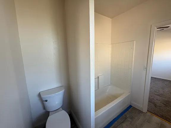 150 North Acacia Avenue Ripon, CA 95366 - Photo 28 of 54 a bathroom with a granite countertop toilet and a bathtub
