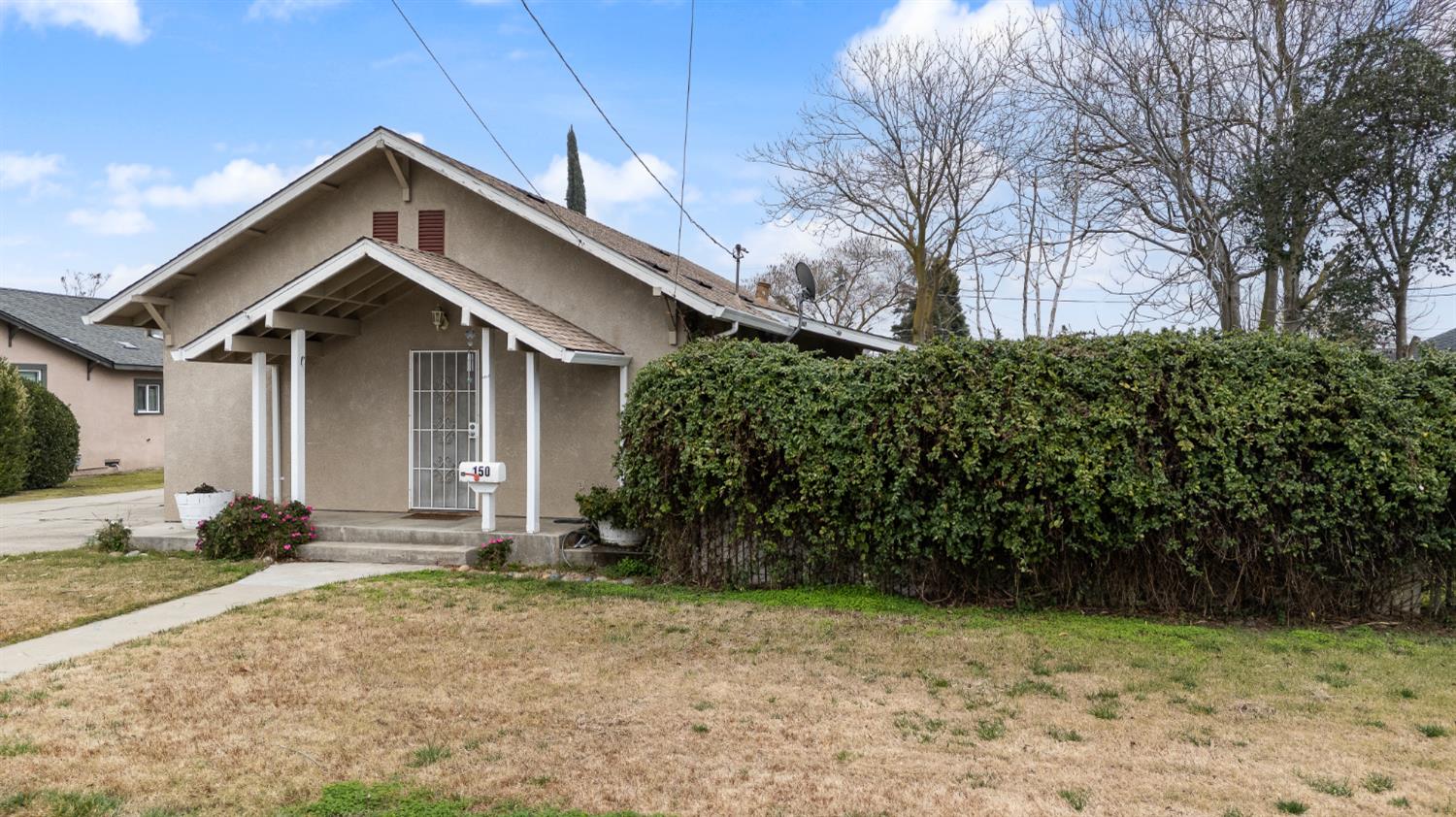 150 North Acacia Avenue Ripon, CA 95366 - Photo 4 of 54 a front view of a house with garden