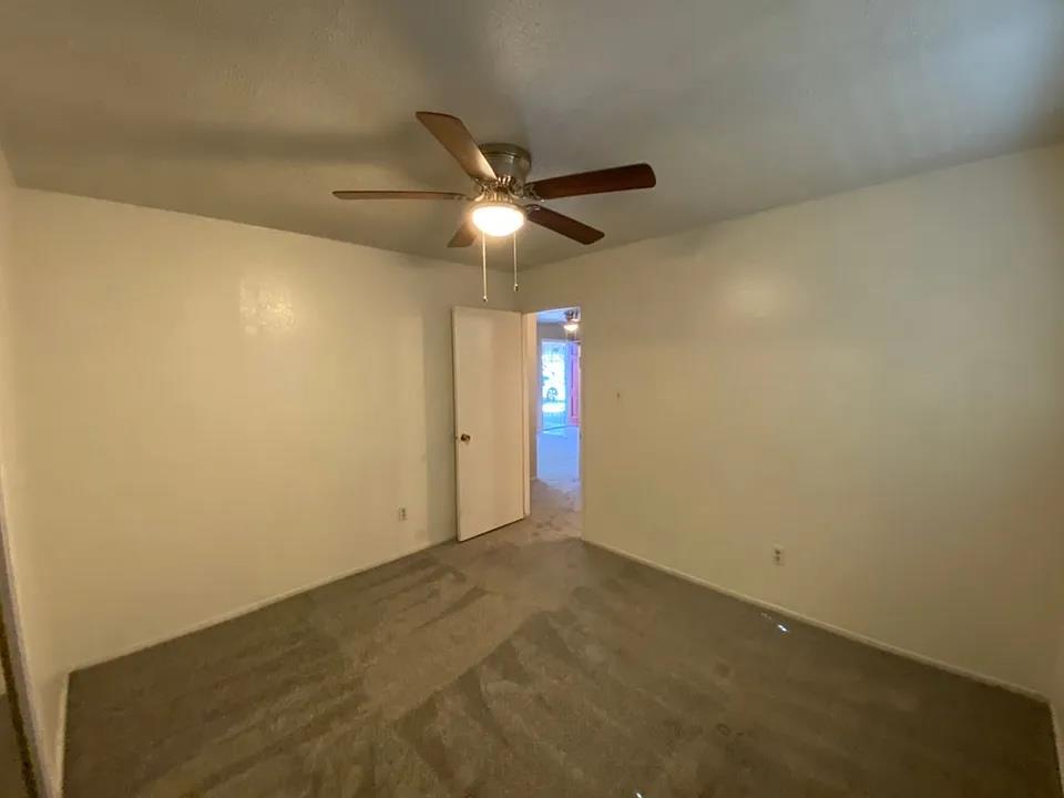 150 North Acacia Avenue Ripon, CA 95366 - Photo 45 of 54 an empty room with a ceiling fan and a window