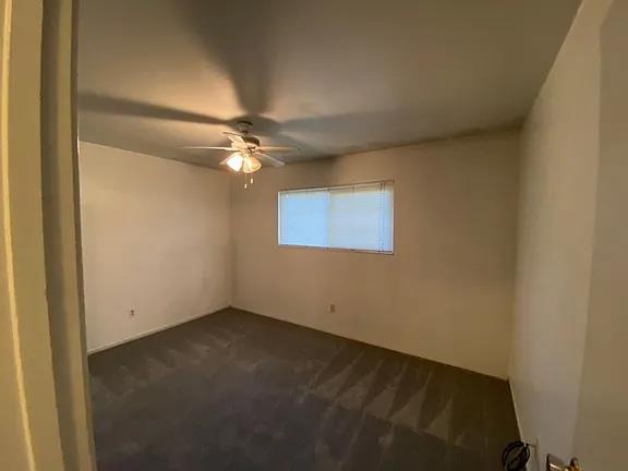 150 North Acacia Avenue Ripon, CA 95366 - Photo 49 of 54 an empty room with a fan and a window