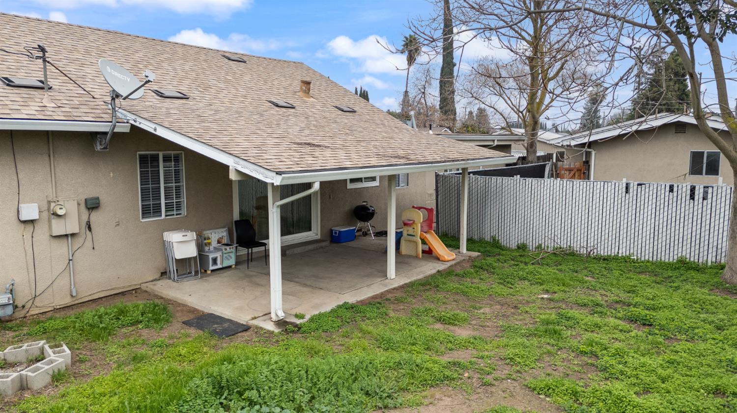 150 North Acacia Avenue Ripon, CA 95366 - Photo 6 of 54 a view of a house with a backyard and a large tree