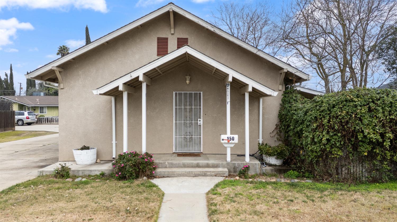 150 North Acacia Avenue Ripon, CA 95366 - Photo 8 of 54 a front view of a house with garden