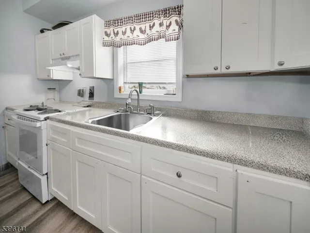 a kitchen with appliances cabinets and a sink