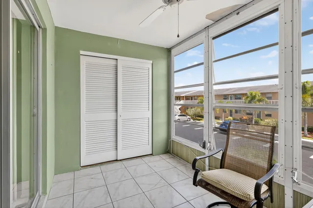 a room with pool table and windows