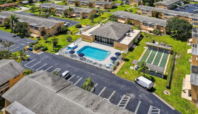an aerial view of a house with a garden and swimming pool