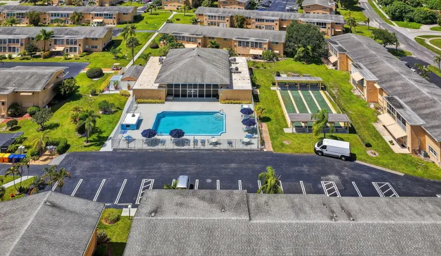 an aerial view of a swimming pool with a yard