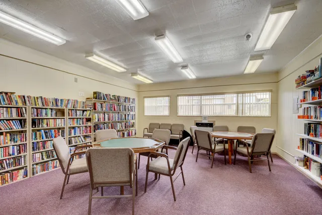 a view of a dining room with furniture and a bookshelf