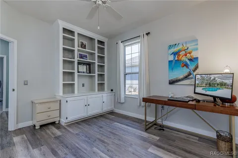 a view of a workspace with furniture and a window