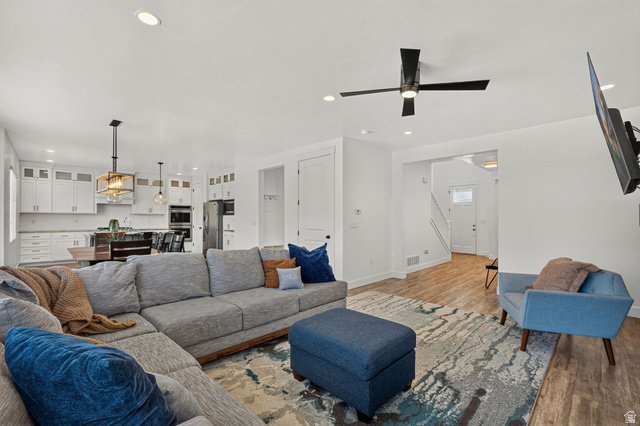 6536 West Muirfield Road Highland, UT 84003 - Photo 2 of 48 Open-concept living area with wood-finish flooring and recessed lighting