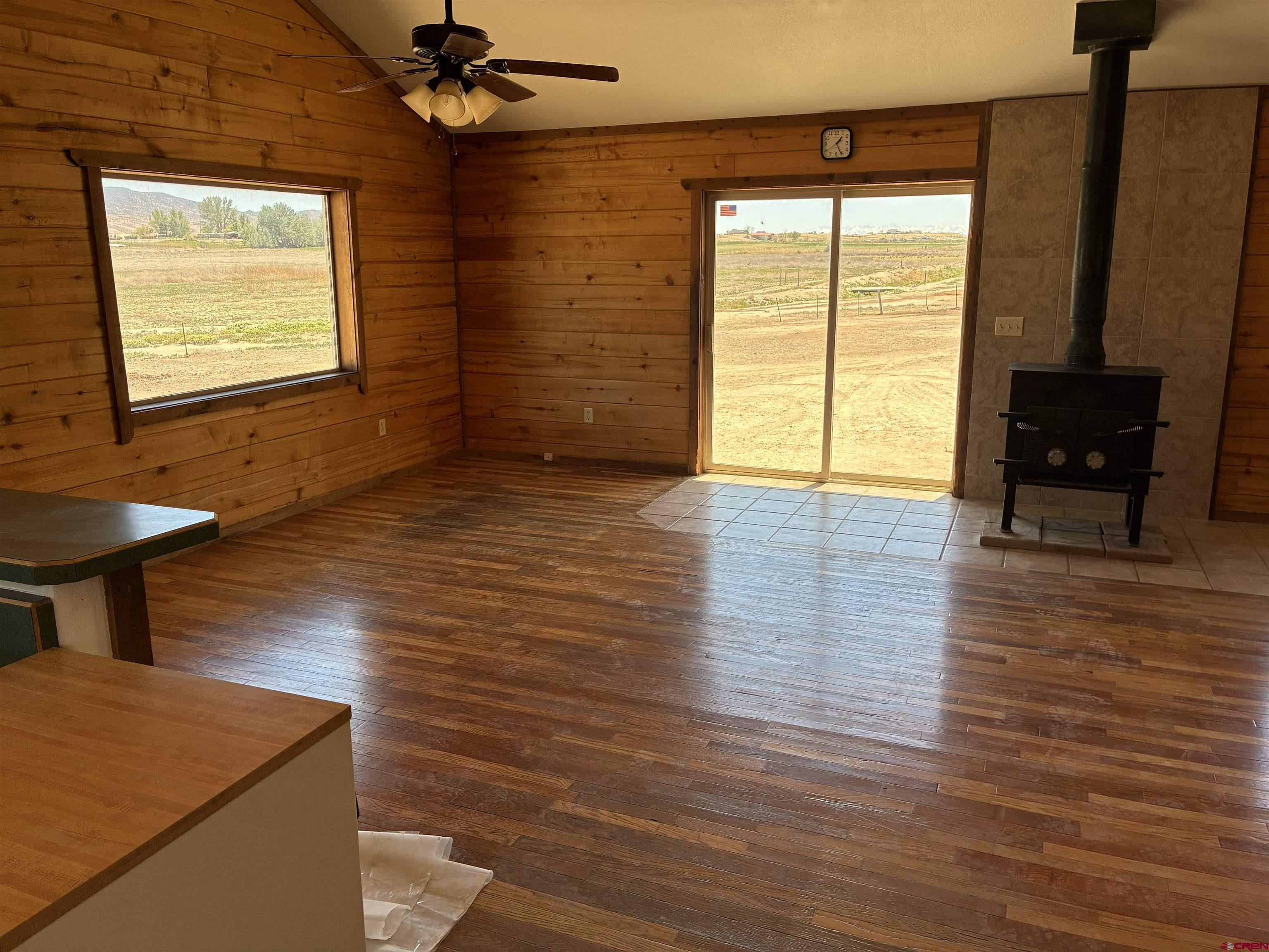 4491 2300th Road Delta, CO 81416 - Photo 3 of 25 a view of an empty room with a window and wooden floor
