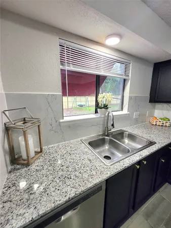 a kitchen with sink and window
