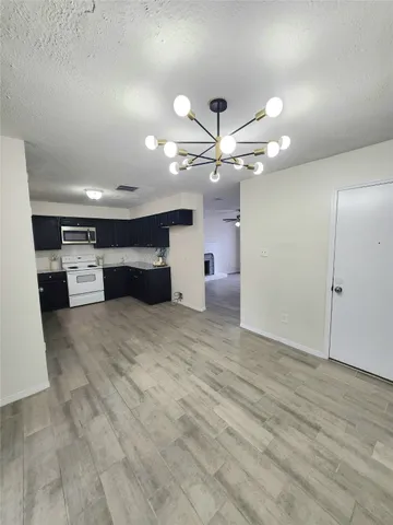 a view of a kitchen with a sink and a ceiling fan