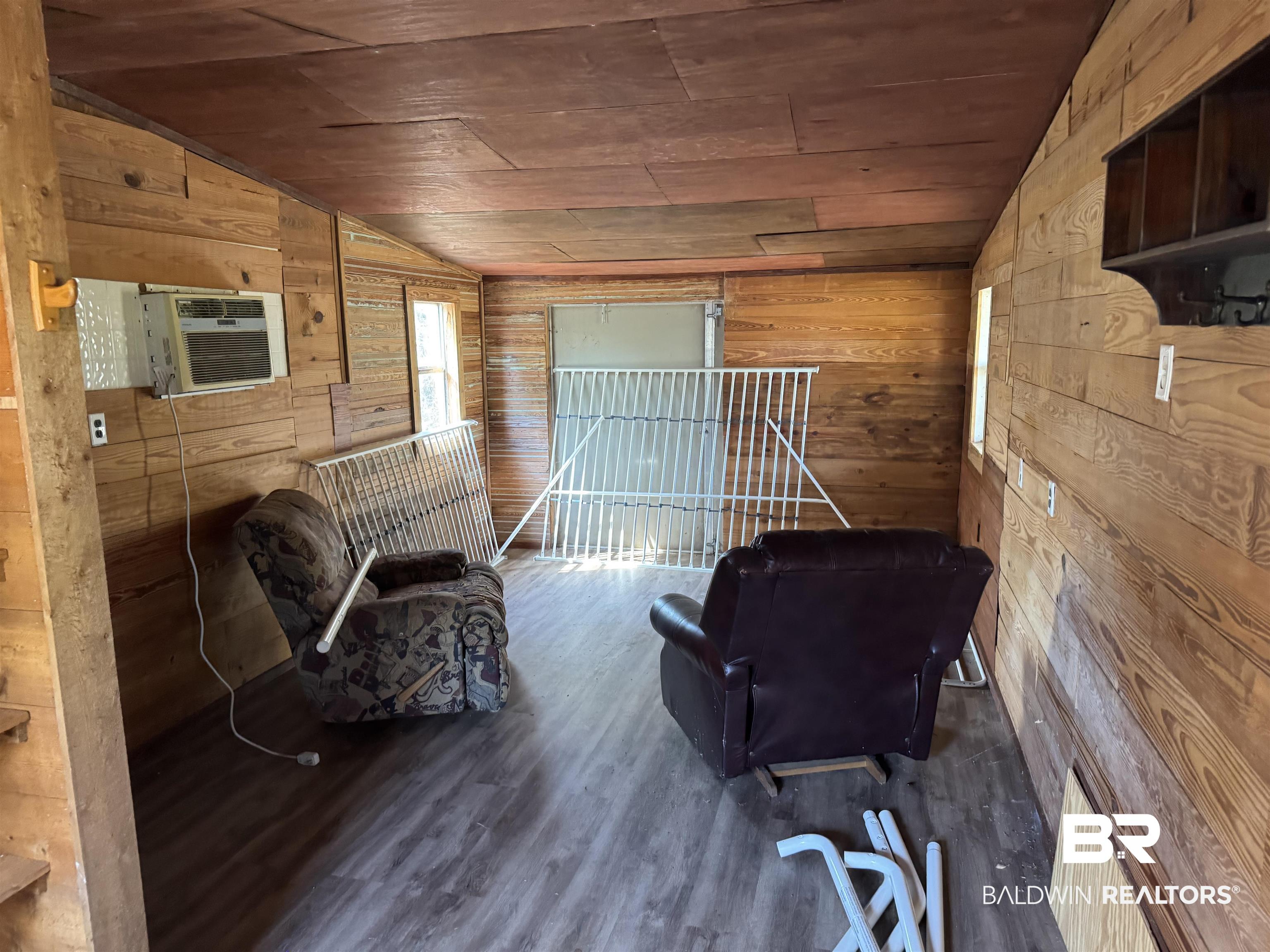 516 Mill Creek Road Frisco City, AL 36445 - Photo 16 of 32 Sitting room featuring wood walls, a vaulted wood ceiling, and wood finished floors
