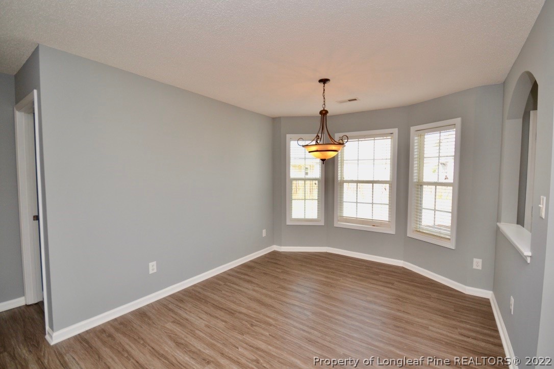2330 Chasewater Road Fayetteville, NC 28306 - Photo 14 of 44 a view of empty room with wooden floor and fan