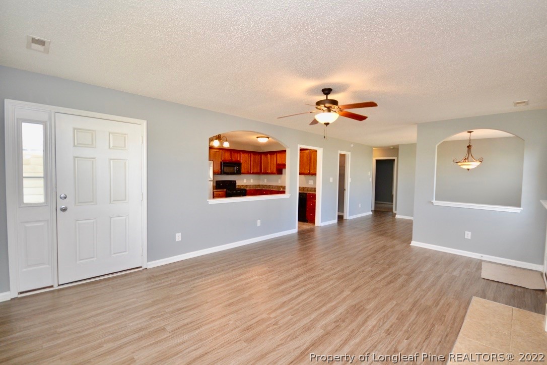 2330 Chasewater Road Fayetteville, NC 28306 - Photo 2 of 44 wooden floor in an empty room with a window