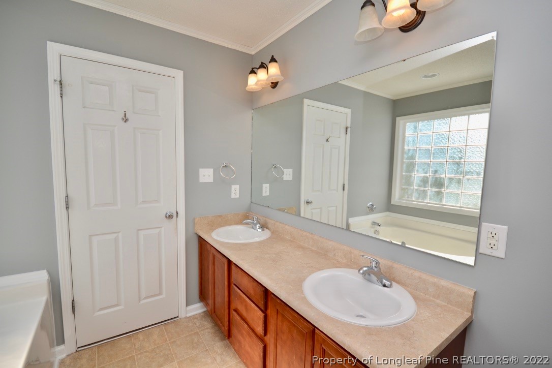 2330 Chasewater Road Fayetteville, NC 28306 - Photo 29 of 44 a bathroom with a sink and a mirror