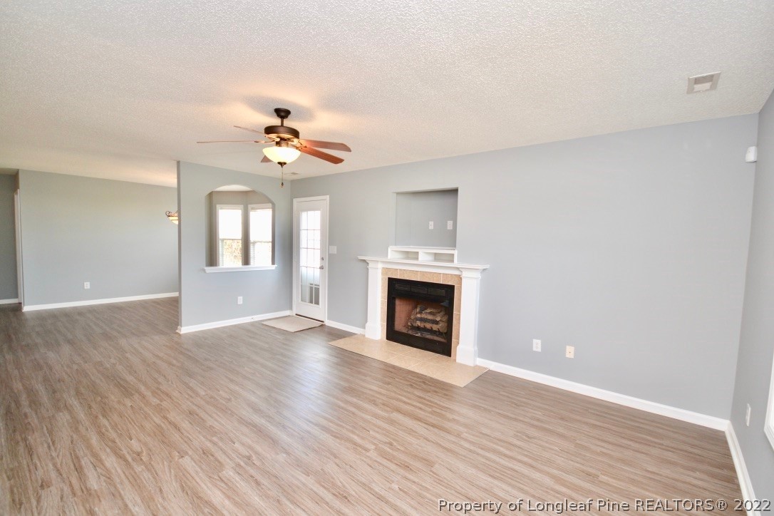 2330 Chasewater Road Fayetteville, NC 28306 - Photo 3 of 44 a view of an empty room with a fireplace and a window