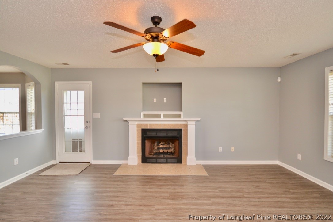 2330 Chasewater Road Fayetteville, NC 28306 - Photo 5 of 44 a view of an empty room with wooden floor and a fireplace