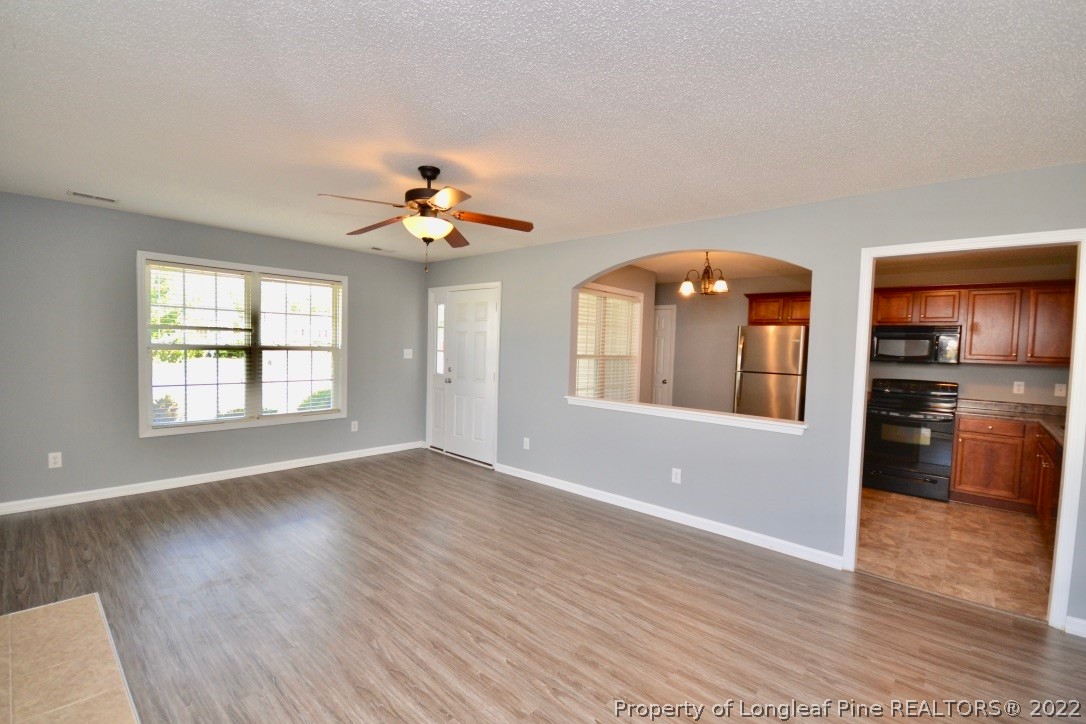 2330 Chasewater Road Fayetteville, NC 28306 - Photo 6 of 44 a view of an empty room with window and wooden floor