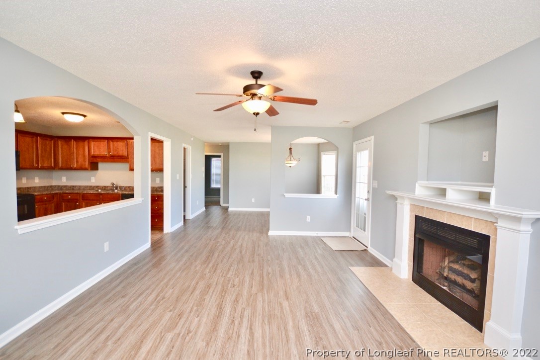 2330 Chasewater Road Fayetteville, NC 28306 - Photo 7 of 44 a view of a livingroom with a fireplace a chandelier and wooden floor