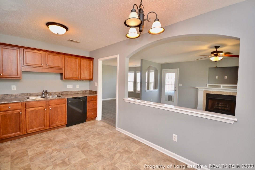 2330 Chasewater Road Fayetteville, NC 28306 - Photo 9 of 44 a kitchen with stainless steel appliances granite countertop a stove and cabinets