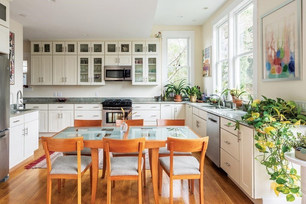 26 Islington Road Newton, MA 02466 - Photo 6 of 18 a dining table with chairs and potted plant