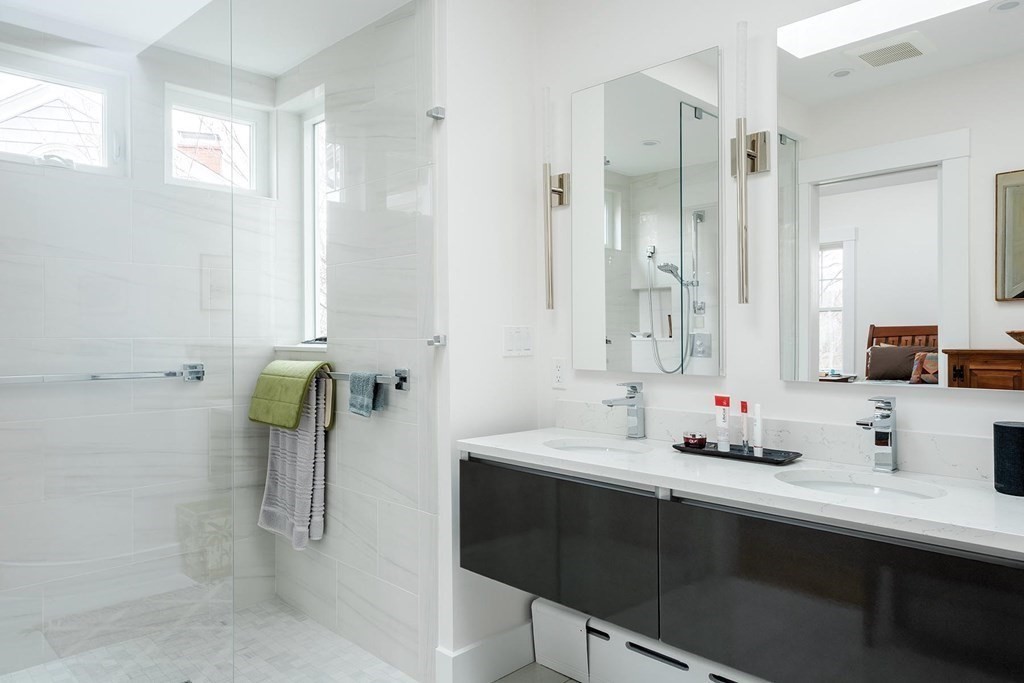 26 Islington Road Newton, MA 02466 - Photo 10 of 18 a bathroom with a tub sink and mirror