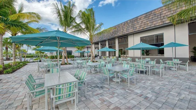 a view of a patio with table and chairs under an umbrella