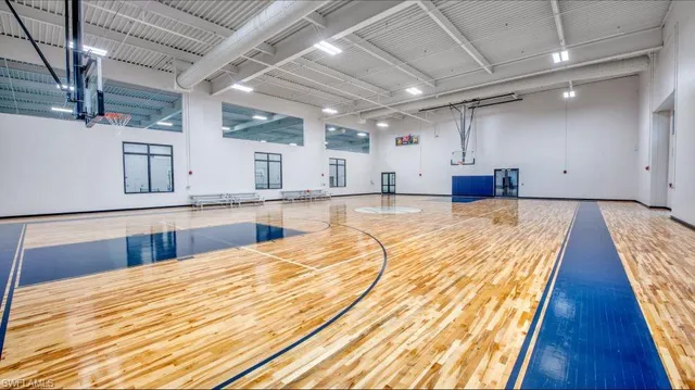 a large room with kitchen island a wooden floor
